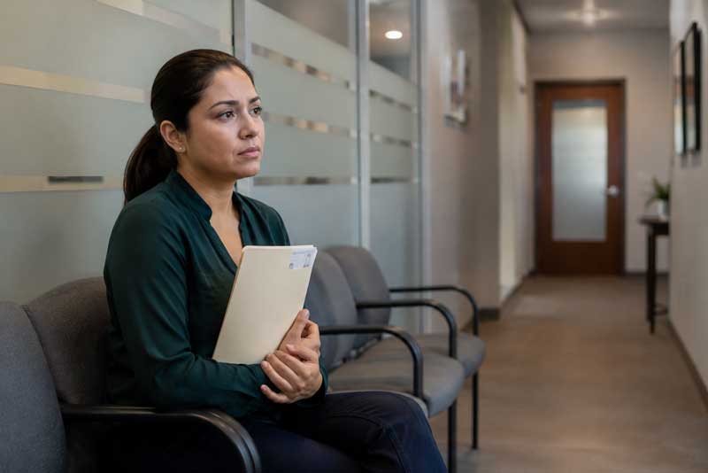 Woman waiting for a legal consultation about her Green Card after divorce